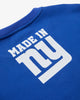 An angled artisitc photo of the rear of a Blue Crew Neck , featuring the text Made in NY using the OFFICIAL NFL GIANTS Jersey Font. 