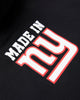 An angled artisitc photo of the rear of a Black Hoodie, featuring the text Made in NY using the OFFICIAL NFL GIANTS Jersey Font.