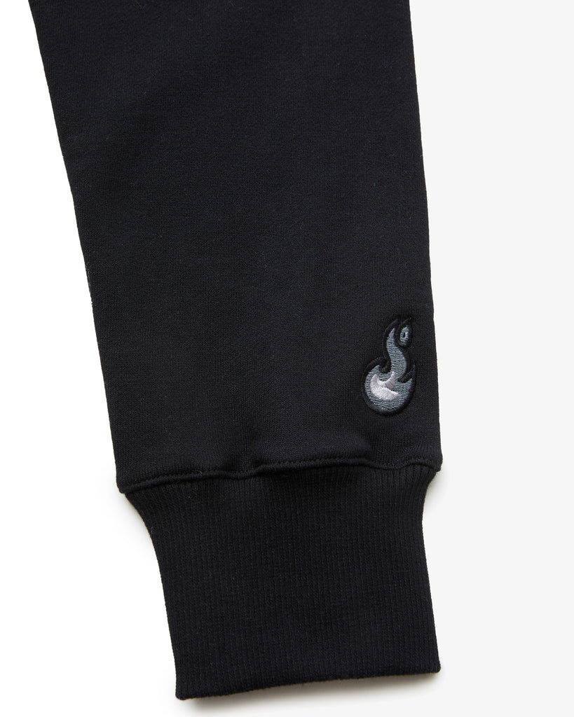 A zoomed in shot on a Black Hoodie , featuring the sleeves and clean embroidery detail-work.