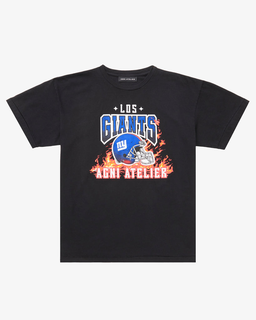 A Black Tee Shirt with Los GIANTS emblazoned upon it, featuring a graphic of the NY GIANTS NFL FOOTBALL TEAM HELMET  and the  Agni Atelier logo in the foreground, with flames in the background.